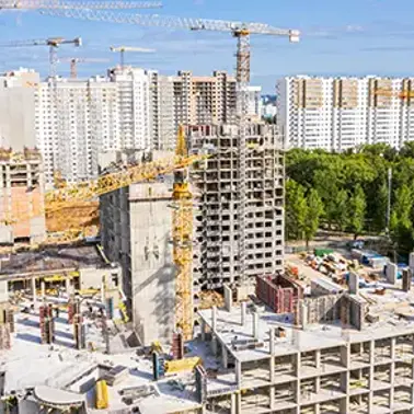 Urban construction site with cranes and buildings under development.
